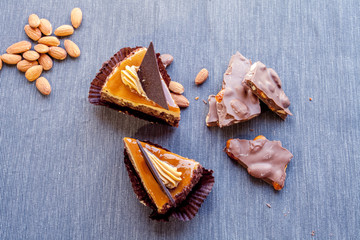 Desserts for two persons consist of cakes and portion of chocolate with handful of almonds, flat-lay shoot