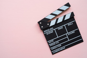 Cinema clapperboard on pink wooden background - Movie entertainment concept