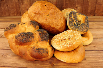 Freshly baked Kosher bread products on a wooden background