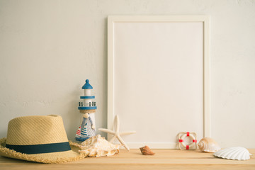 White vintage photo frame on old wooden table over white wall background with beach accessories - Summer tropical beach holiday traveling concept