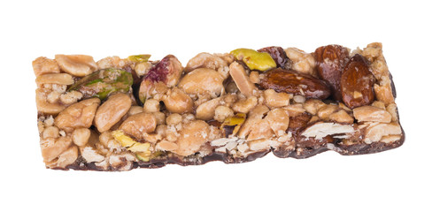 Yummy stick with almonds, pistachios and peanuts. Close-up of sweet chocolate confection with mix of different nuts in honey and caramel. Isolated on white background.