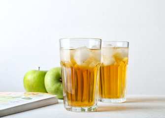 Two glasses of fresh apple juice on table
