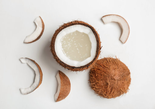 Coconut water and fresh nuts on white background