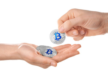 Man giving silver bitcoin to woman on white background