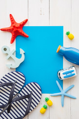 Flat lay of tropical beach summer holiday template with beach summer accessories for traveling on white wooden background