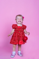 little girl laughing on a pink background