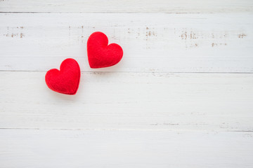 Two red hearts on white wooden background - valentines day concept