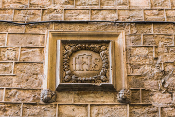 IHS Carved Into Stone Wall