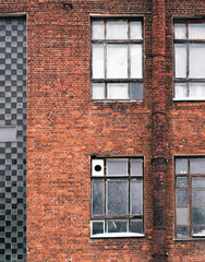 Fragment of the facade of the old building. Windows and brick walls