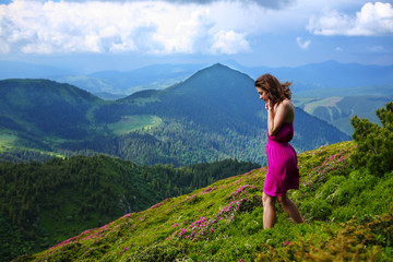 Naklejka na ściany i meble The girl enjoys landscapes in the mountains of the Carpathians.