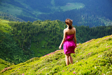 The girl enjoys landscapes in the mountains of the Carpathians.