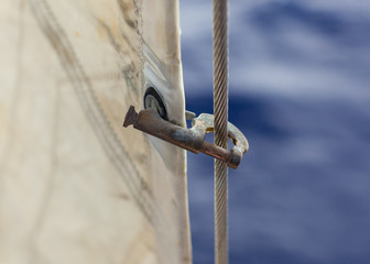 Jib hank (stags) on a forestay, heavely used. Holding a jib.