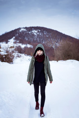 Young woman walking in snow