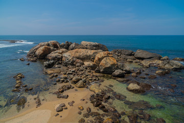 Fototapeta na wymiar Large rocks in the ocean near the shore.