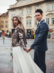 Groom and bride in historic centre of Prague. Wedding