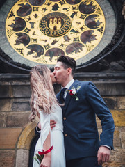 Obraz na płótnie Canvas Groom and bride in historic centre of Prague. Wedding