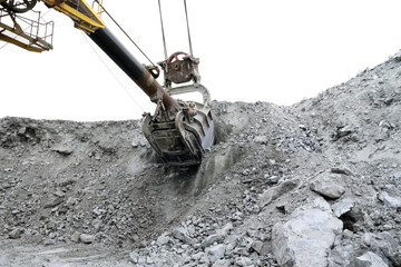 Volume of excavator bucket 10 m3 The bucket of the excavator cuts into a mountain of stones.