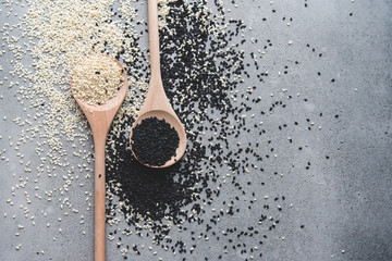 white and black sesame on wooden spoons