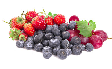 Mix berries isolated on a white. Ripe blueberries, currants and strawberries with mint. Berries and fruits with copy space for text. Background berries.