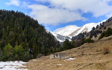 Сaucasian spring mountains with snow peaks, panorama. Dombai, Russia.