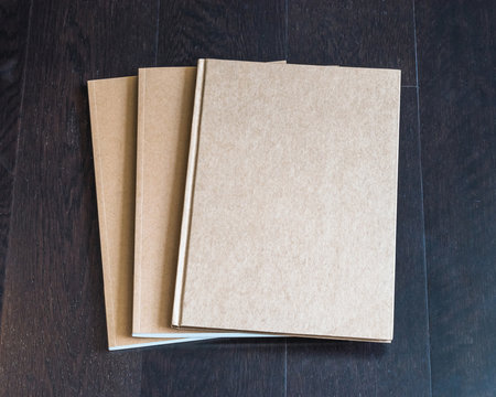Blank letter-size book, catalog, magazines, brochure, note cover template with recycle brown paper texture on dark wood table
