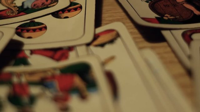 tracking shot on playing cards, gambling addiction