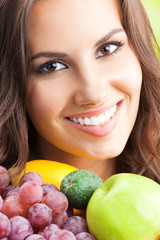 Woman with plate of fruits, outdoors