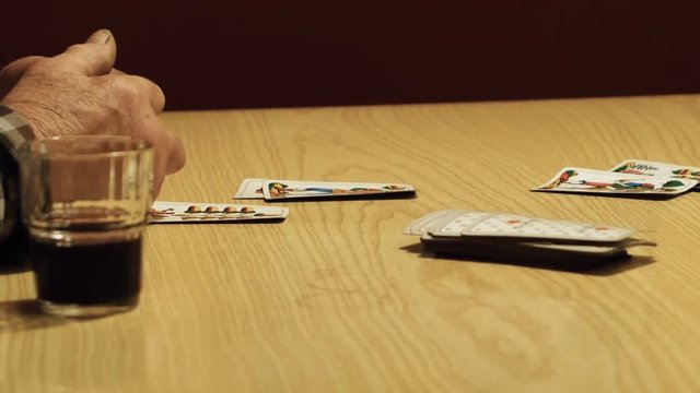 close up, counting the points of the match, we see a hand of elder playing cards