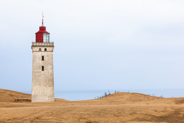 Lighthouse at Råbjerg mile in Denmark in the sand dunes