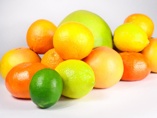 Pile of fresh colorful citrus fruits ready to be squeezed for healthy breakfast. Fruits are captured from different angles.