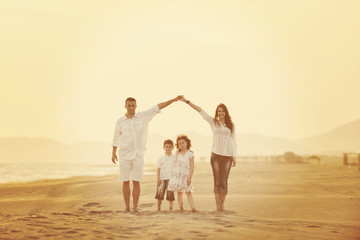 happy young family have fun on beach at sunset