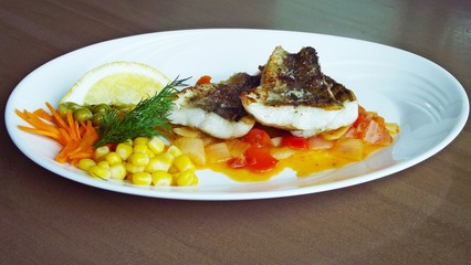 Tasty fried fish with vegetables.