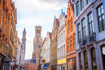 Fototapeta na wymiar The Belfry Tower (aka Belfort) and traditional narrow streets in Bruges (Brugge), Belgium