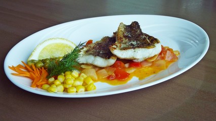 Tasty fried fish with vegetables.