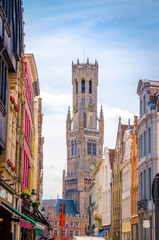 Obraz premium The Belfry Tower (aka Belfort) and traditional narrow streets in Bruges (Brugge), Belgium