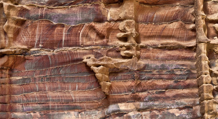 Laminated sandstone in Petra, Jordan, with strong red, yellow, orange and brown colours