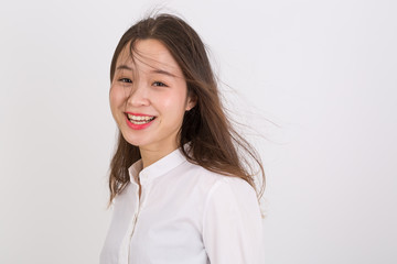 Fototapeta premium Portrait of Beautiful Business Woman Wearing White Shirt. Smiling Young Asian Business Woman.