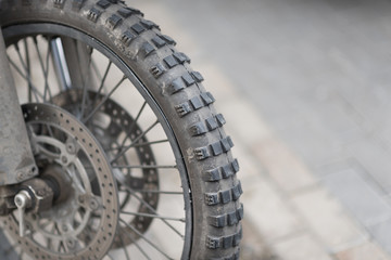 Riders will love. Cropped shot of the wheel of motorbike. Closeup detail of a motorcycle's front wheel and brake disc