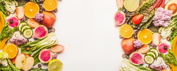 Colorful fruits and vegetables background with half of oranges, and berries , top view, banner or template. Healthy food and clean eating ingredients concept , frame