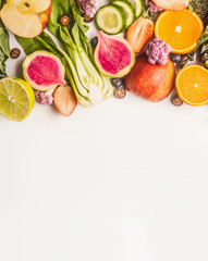 Variety of fresh colorful fruits, citrus and vegetables on white background, top view, border. Healthy food and clean eating ingredients concept