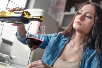 Young woman alcoholic social problems concept sitting pouring wine