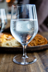 Misted glass of mineral water with bubbles.