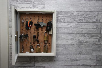 an overflowing metal key cabinet