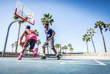 Two basketball players playing outdoor in LA - Powered by Adobe