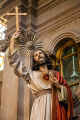 Lisbon, Portugal - October 24, 2016: Jesus Christ statue holding Cross or Crucifix and Sacred Heart on chest. Santo Antonio de Lisboa Church. Saint Anthony of Lisbon (Padua or Padova) church