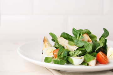 salad with quail egg, cherry tomato, crackers and corn salad on white background