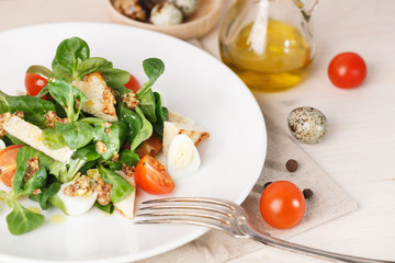 salad with quail egg, cherry tomato, crackers and corn salad on white background