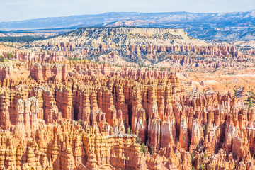 Red-yellow rocks in Bryce Canyon. Panorama of the mountain massif. A tourist place, a stone forest.