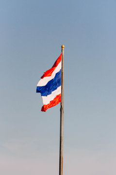 Image of waving Thai Flag of Thailand with blue sky background 