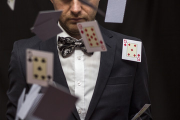 Man with flying playing cards